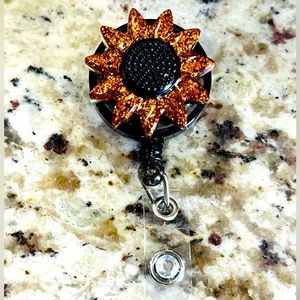Orange and Black sunflower badge reel.